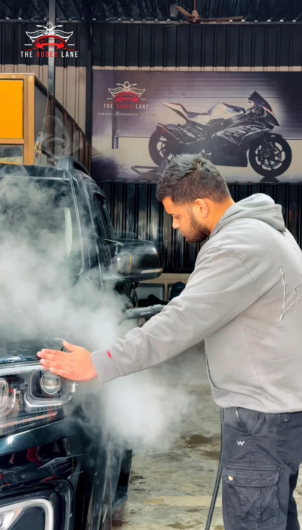 The Rodeo Lane technician steam cleaning a vehicle